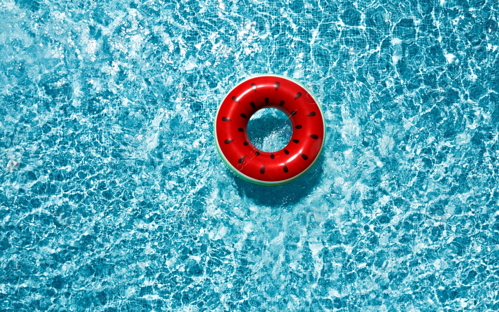 Image of Inflatable ring floating in swimming pool, top view. Summer vacation