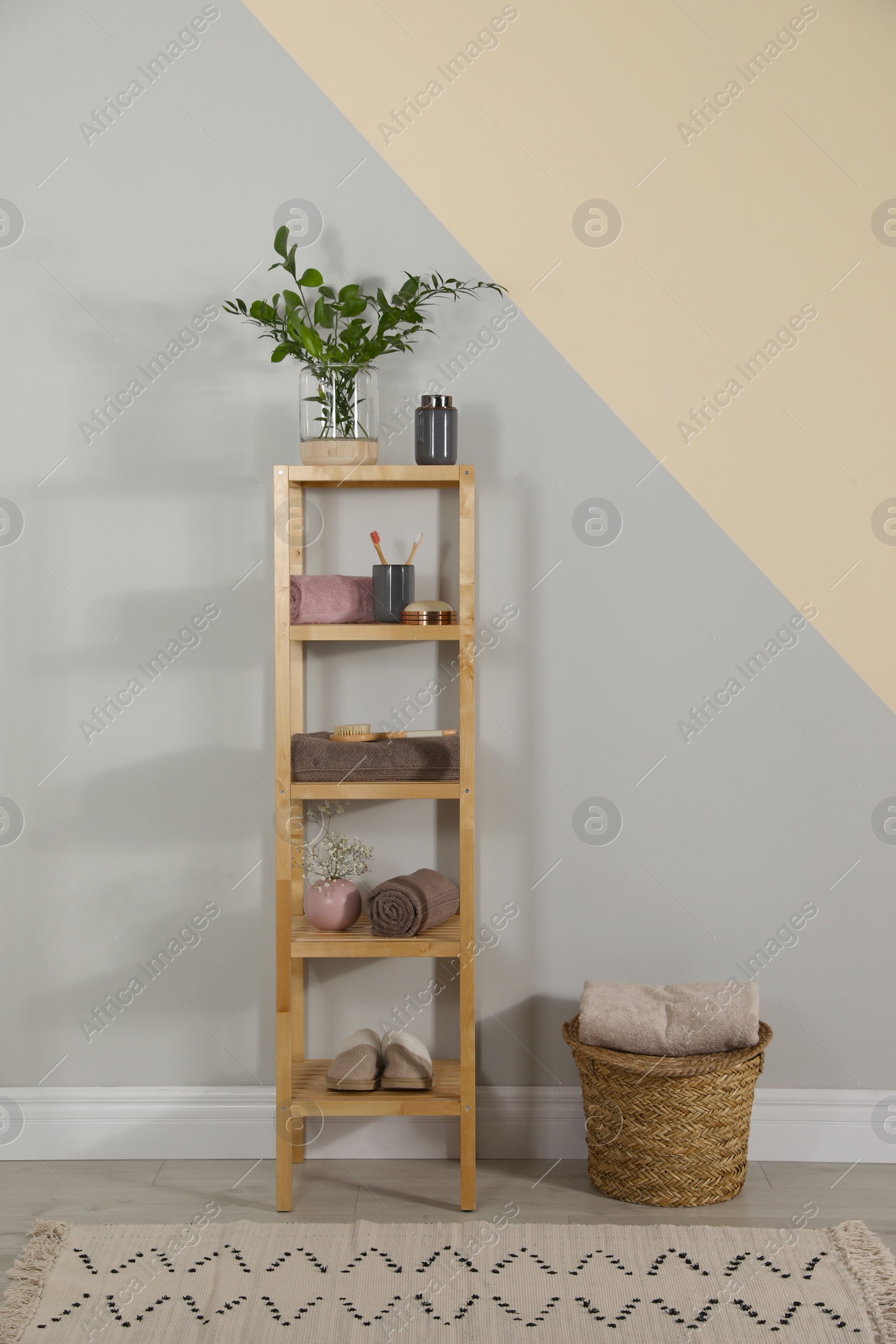 Photo of Shelving unit with toiletries near light wall indoors. Bathroom interior element