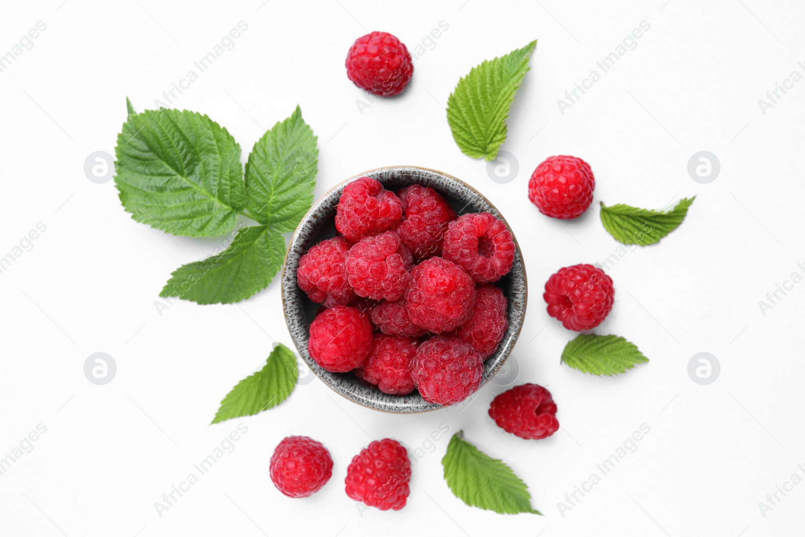 Photo of Tasty ripe raspberries and green leaves on white background, flat lay