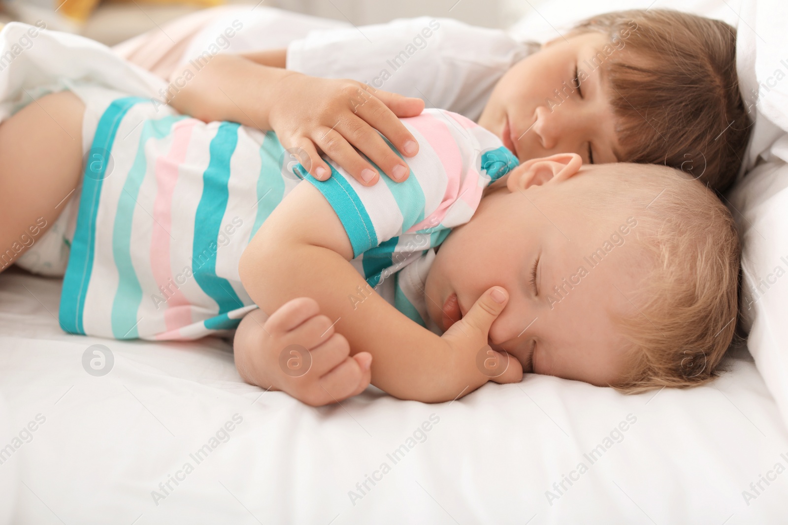 Photo of Little children sleeping in bed at home