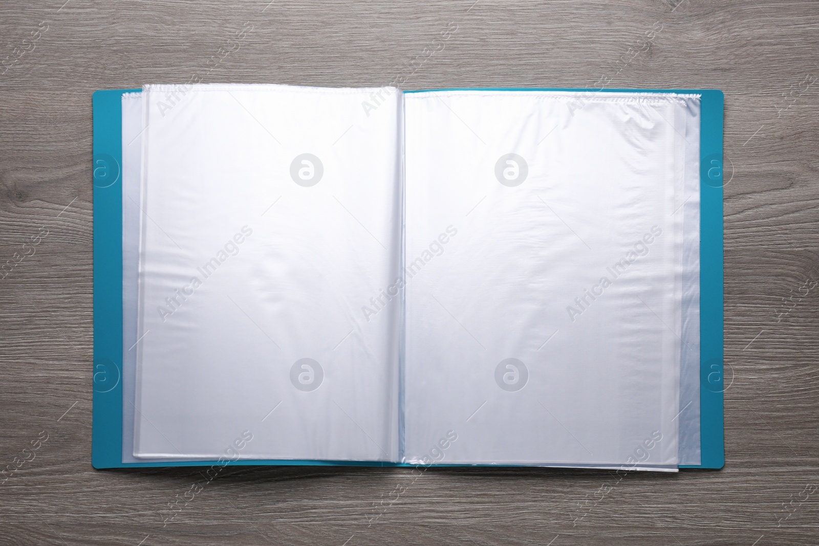 Photo of File folder with punched pockets on wooden table, top view