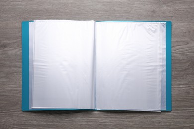 Photo of File folder with punched pockets on wooden table, top view