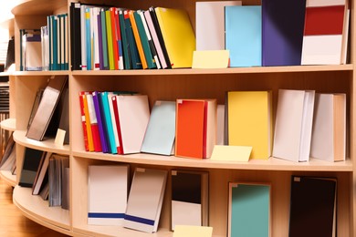 Collection of different books on shelves in library