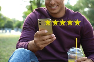 Image of Man with smartphone giving feedback outdoors, closeup. Customer review