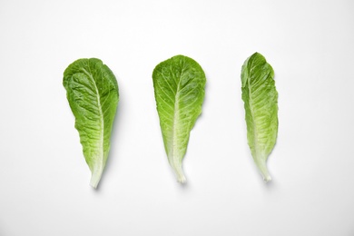 Photo of Leaves of fresh ripe cabbage on white background