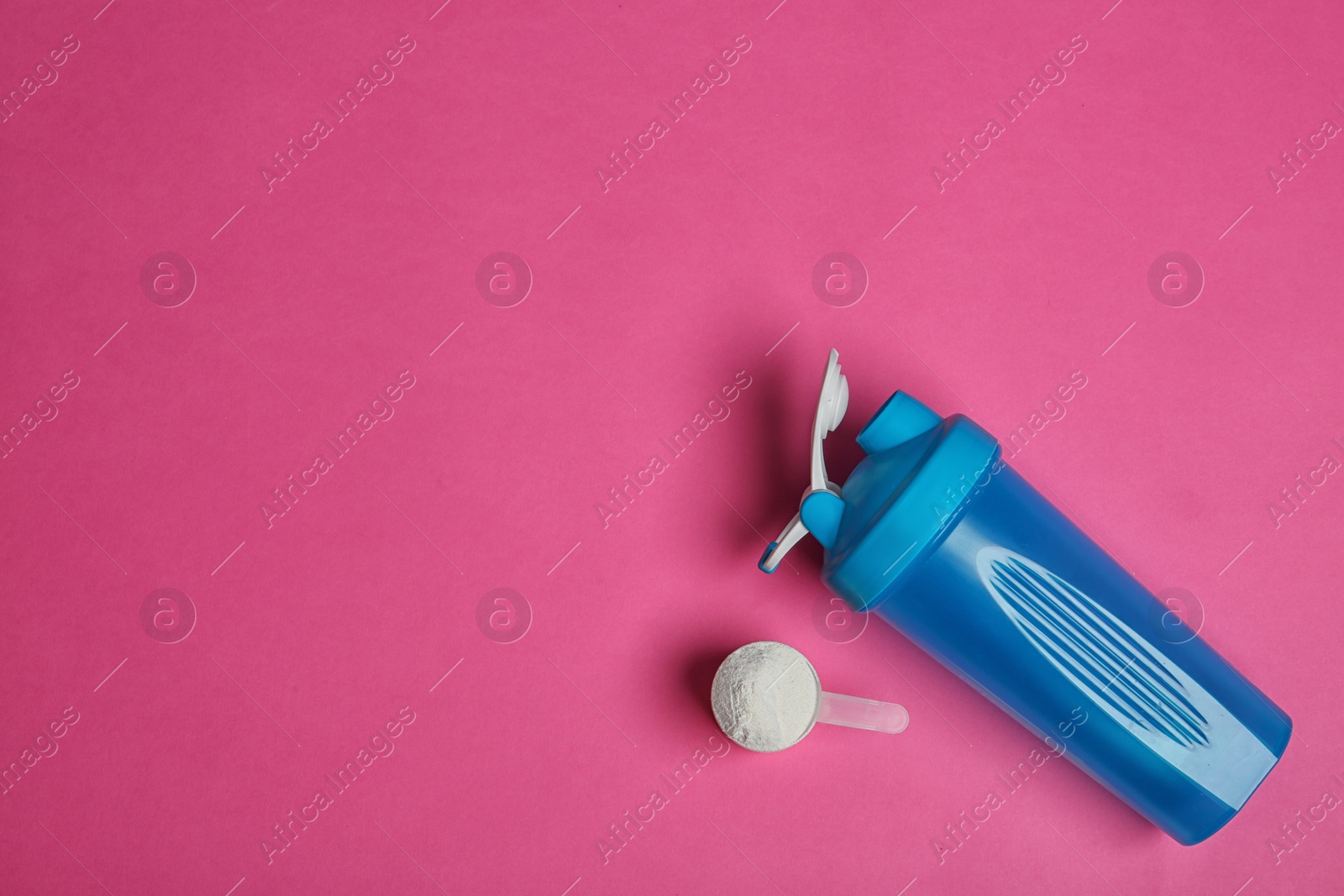 Photo of Bottle, protein powder and space for text on color background, top view. Preparing shake