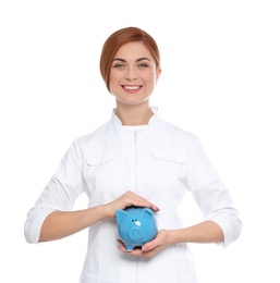 Photo of Portrait of female doctor with piggy bank on white background