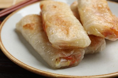 Photo of Delicious fried spring rolls on table, closeup