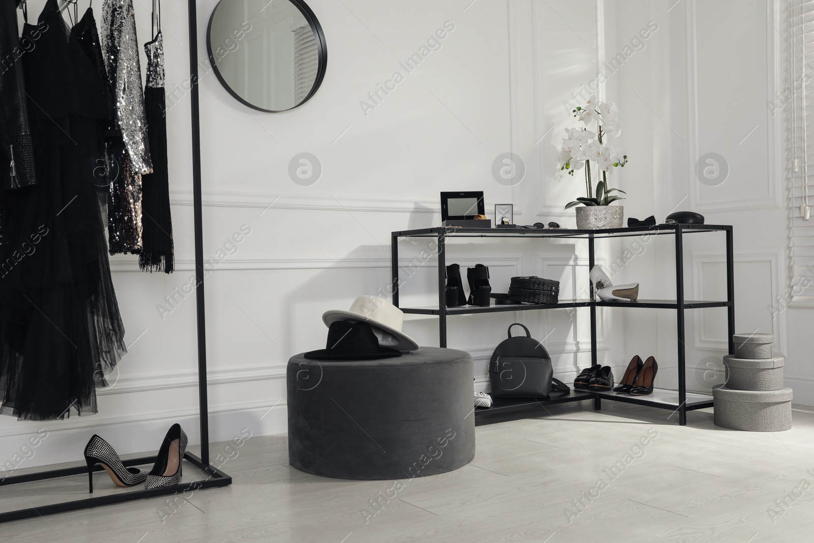 Photo of Stylish dressing room interior with trendy clothes, shoes and accessories