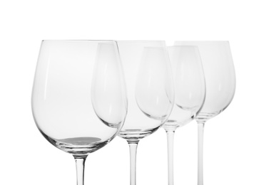 Empty clear wine glasses on white background