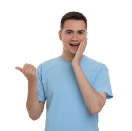 Photo of Special promotion. Happy man pointing at something on white background
