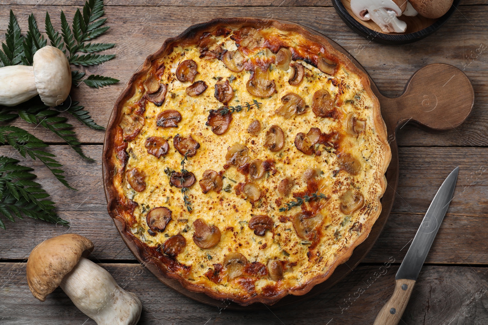 Photo of Flat lay composition with delicious homemade mushroom pie on wooden table