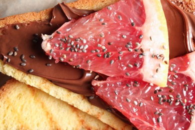 Tasty toast with grapefruit, chocolate paste and chia seeds, closeup