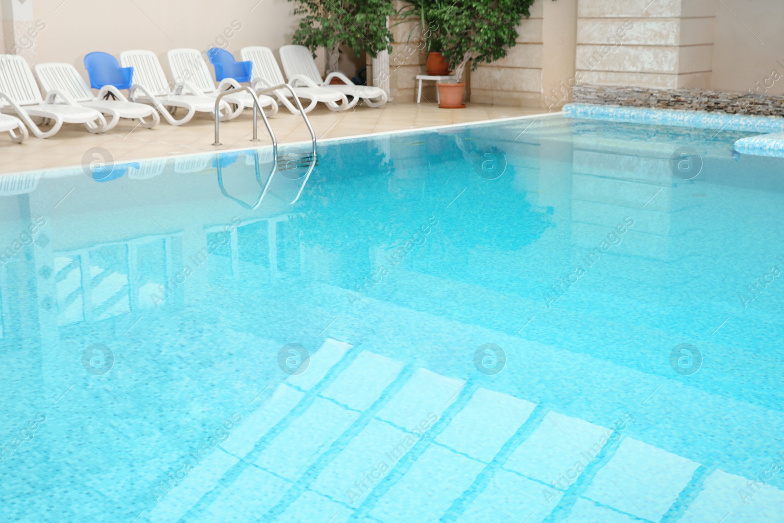 Photo of Swimming pool with refreshing blue water. Time to relax