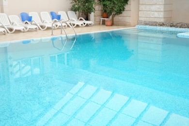 Photo of Swimming pool with refreshing blue water. Time to relax