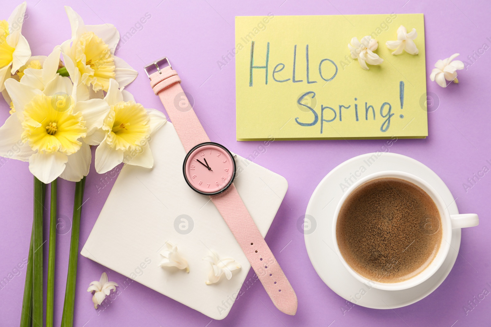 Photo of Flat lay composition with words HELLO SPRING, coffee, wristwatch and fresh flowers on violet background