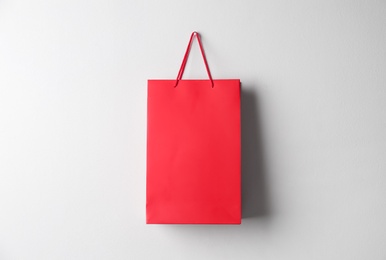 Photo of Paper shopping bag hanging on white wall