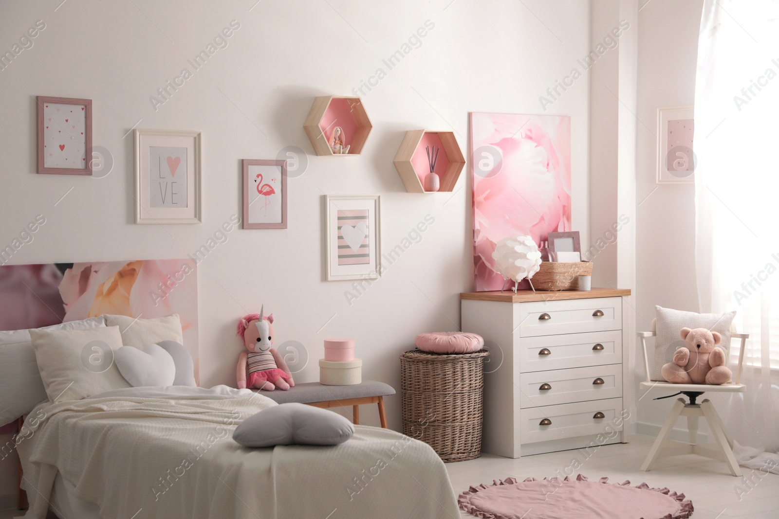 Photo of Modern teenager's room interior with comfortable bed and beautiful pictures