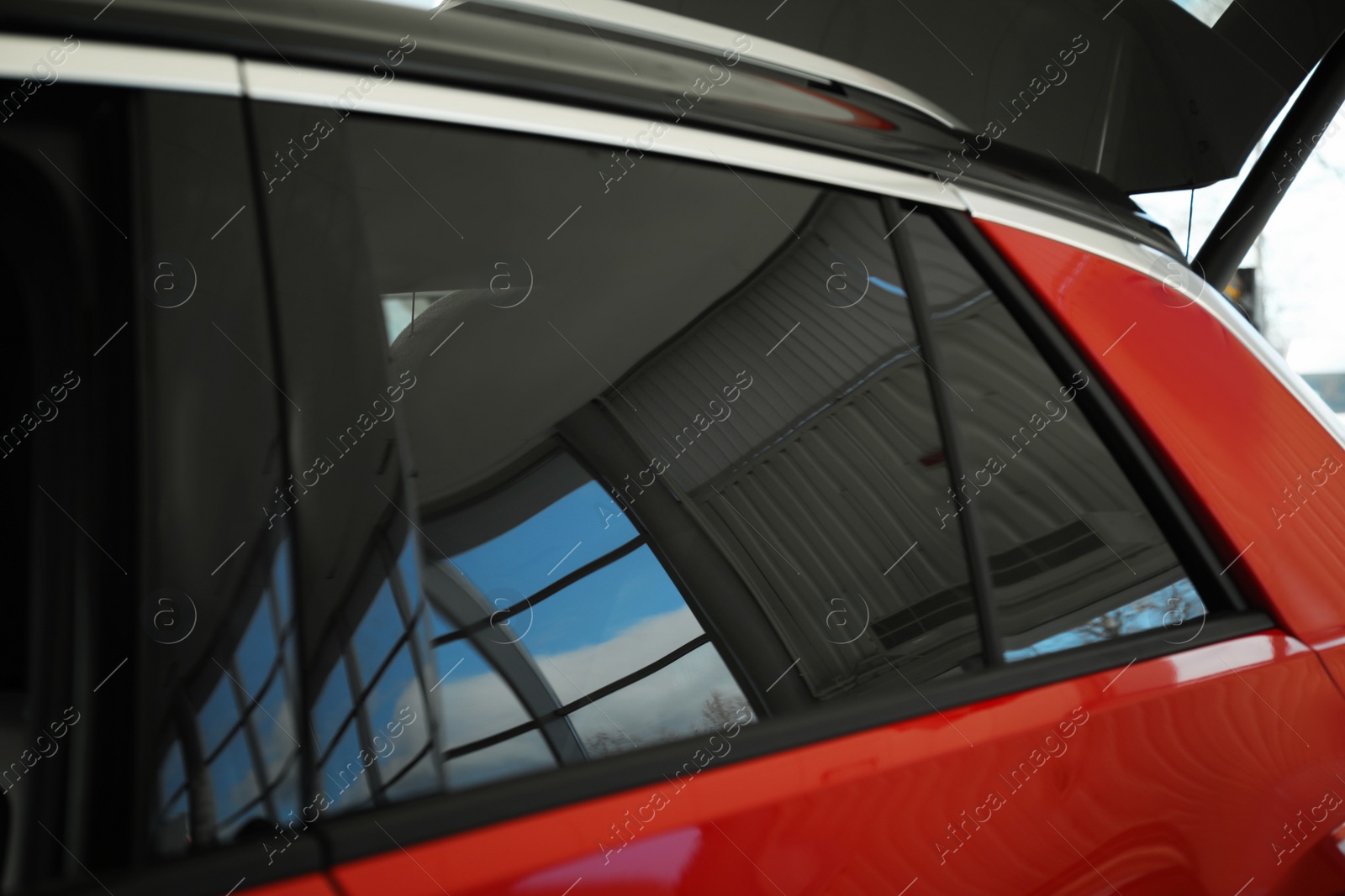 Photo of Modern car with tinting foil on window, closeup