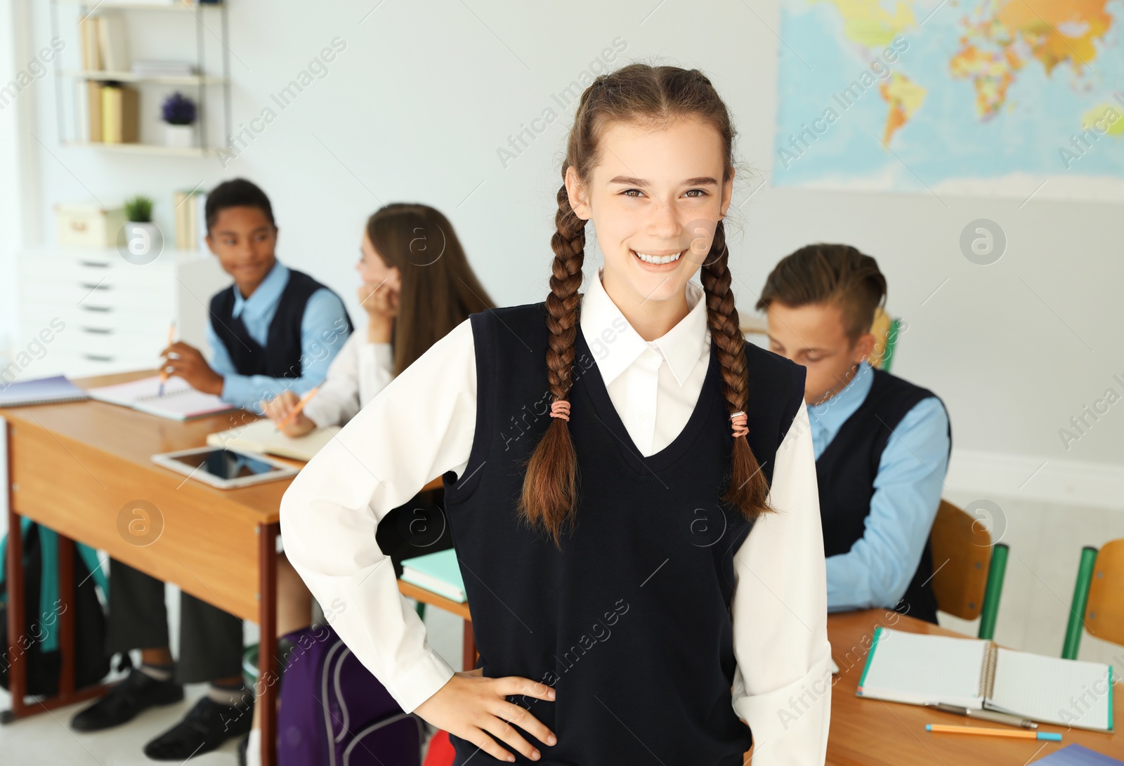 Photo of Teenage student in classroom. Stylish school uniform