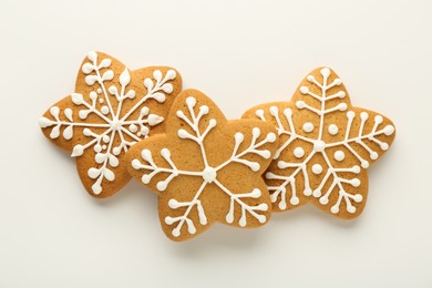 Photo of Tasty Christmas cookies with icing on white background, flat lay