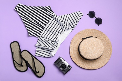 Photo of Flat lay composition with stylish beach accessories on lilac background