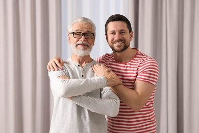 Photo of Happy son and his dad at home