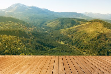 Empty wooden surface and beautiful view of mountains covered with forest