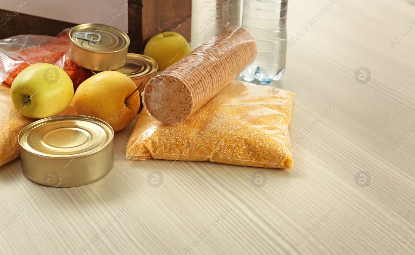 Photo of Collection of different food donations on wooden table