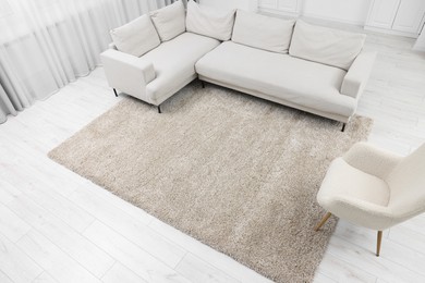 Photo of Fluffy carpet and stylish furniture on floor indoors, above view