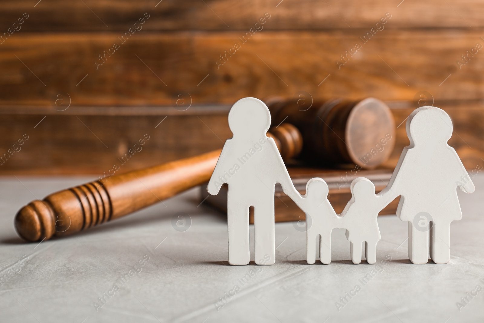 Photo of Family figure and gavel on table. Family law concept