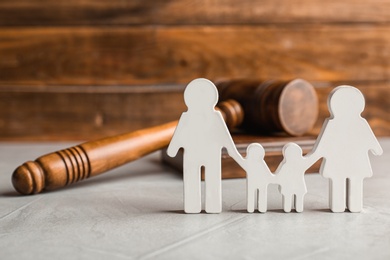 Family figure and gavel on table. Family law concept