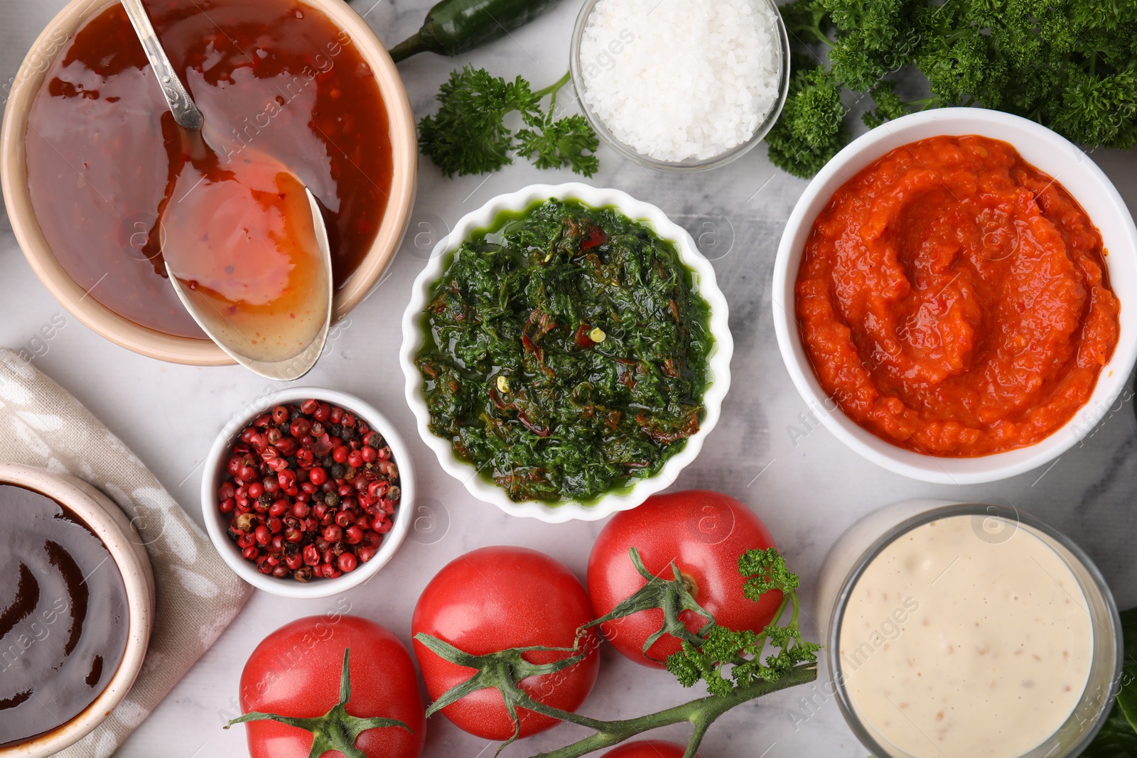 Photo of Different marinades and products on white marble table, flat lay