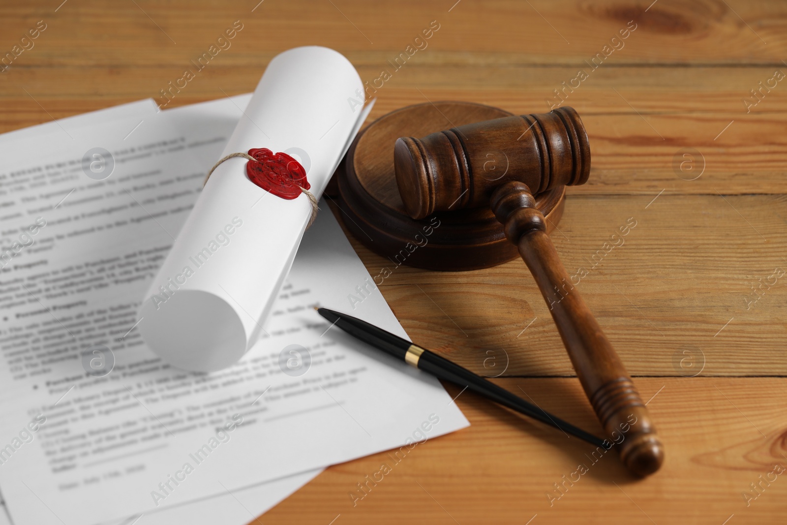 Photo of Notary contract. Documents, gavel and pen on wooden table