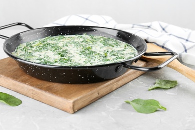 Photo of Tasty spinach dip on grey marble table