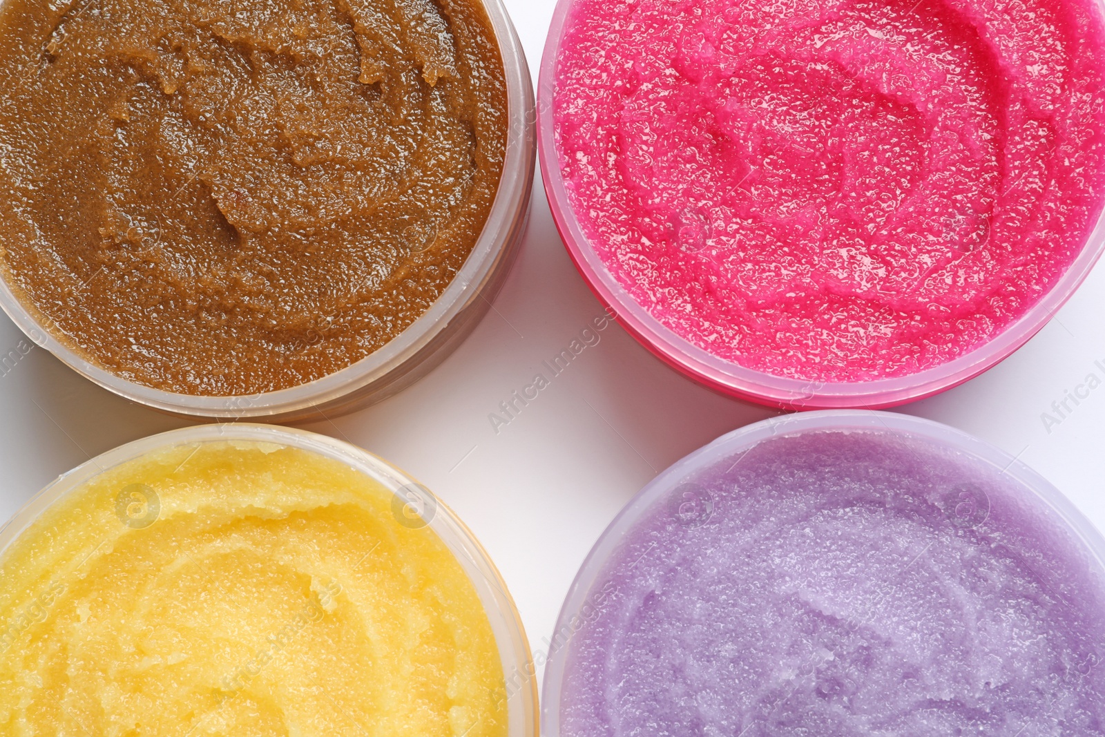 Photo of Containers with natural scrub on white background, top view