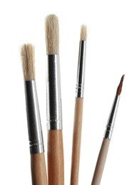 Photo of Set of different paint brushes on white background