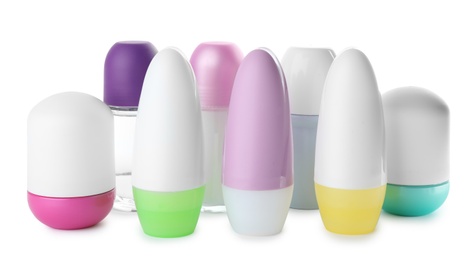 Photo of Set of different female roll-on deodorants on white background
