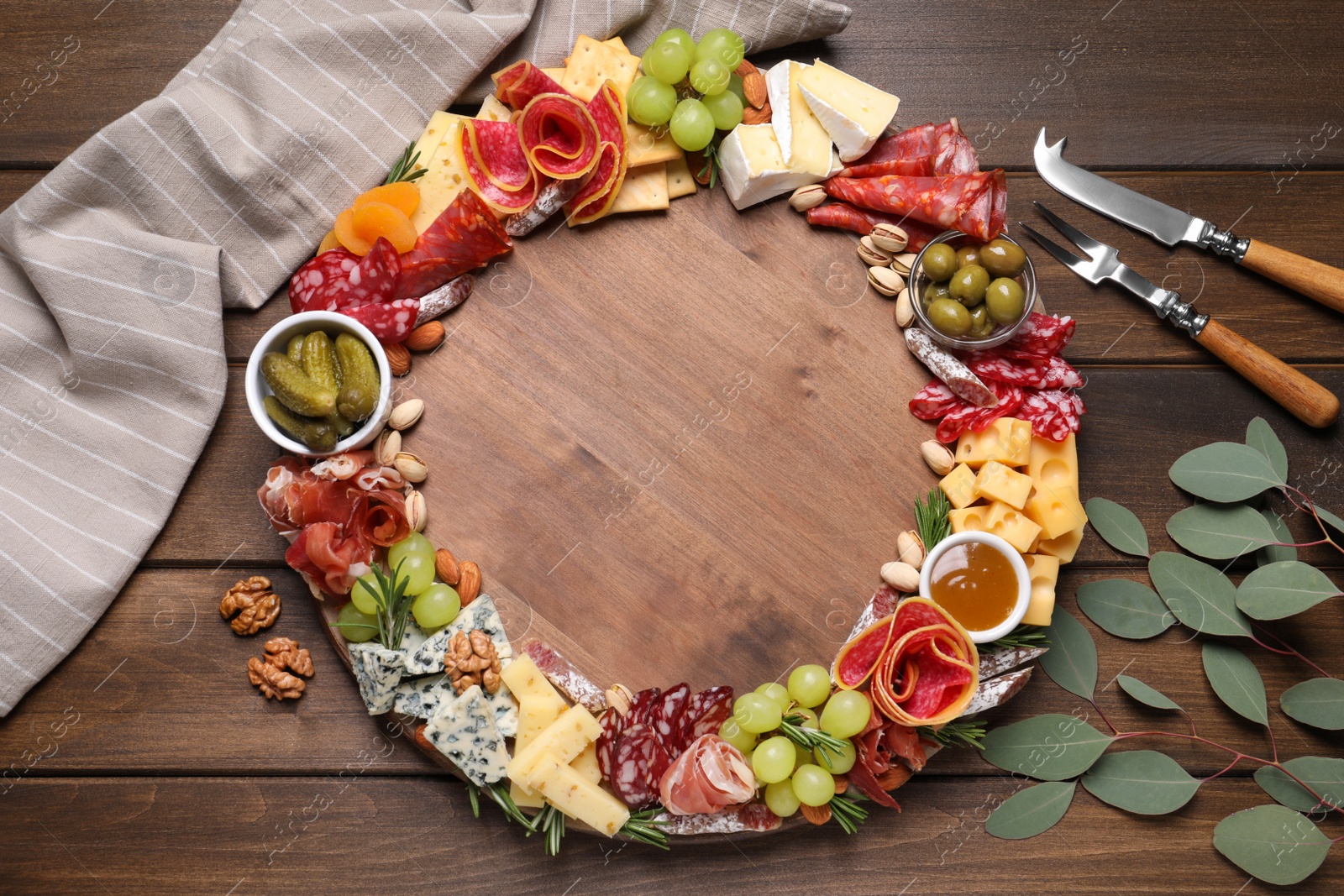 Photo of Assorted appetizers served on wooden table, flat lay. Space for text