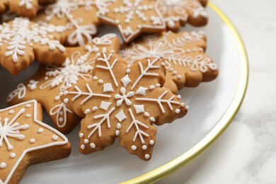 Photo of Tasty Christmas cookies on white marble table, closeup