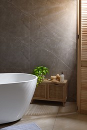 Photo of Stylish bathroom interior with white tub. Idea for design