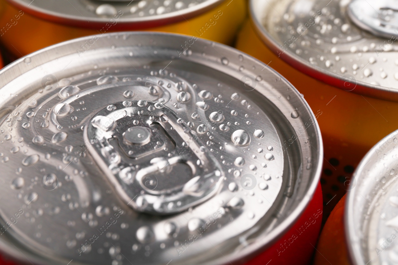 Photo of Energy drinks in wet cans, closeup. Functional beverage