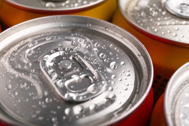 Photo of Energy drinks in wet cans, closeup. Functional beverage