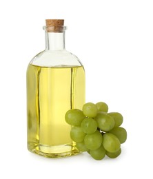 Vegetable fats. Bottle of cooking oil and fresh grapes isolated on white