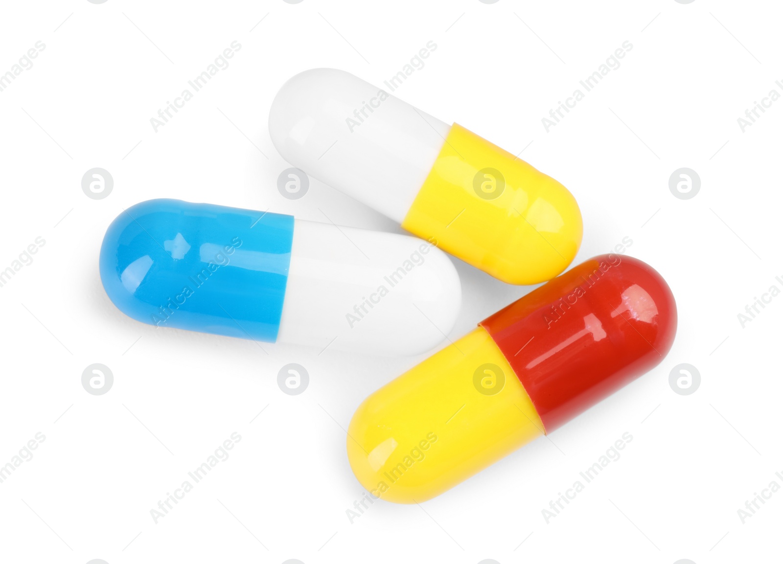 Photo of Three antibiotic pills isolated on white, top view