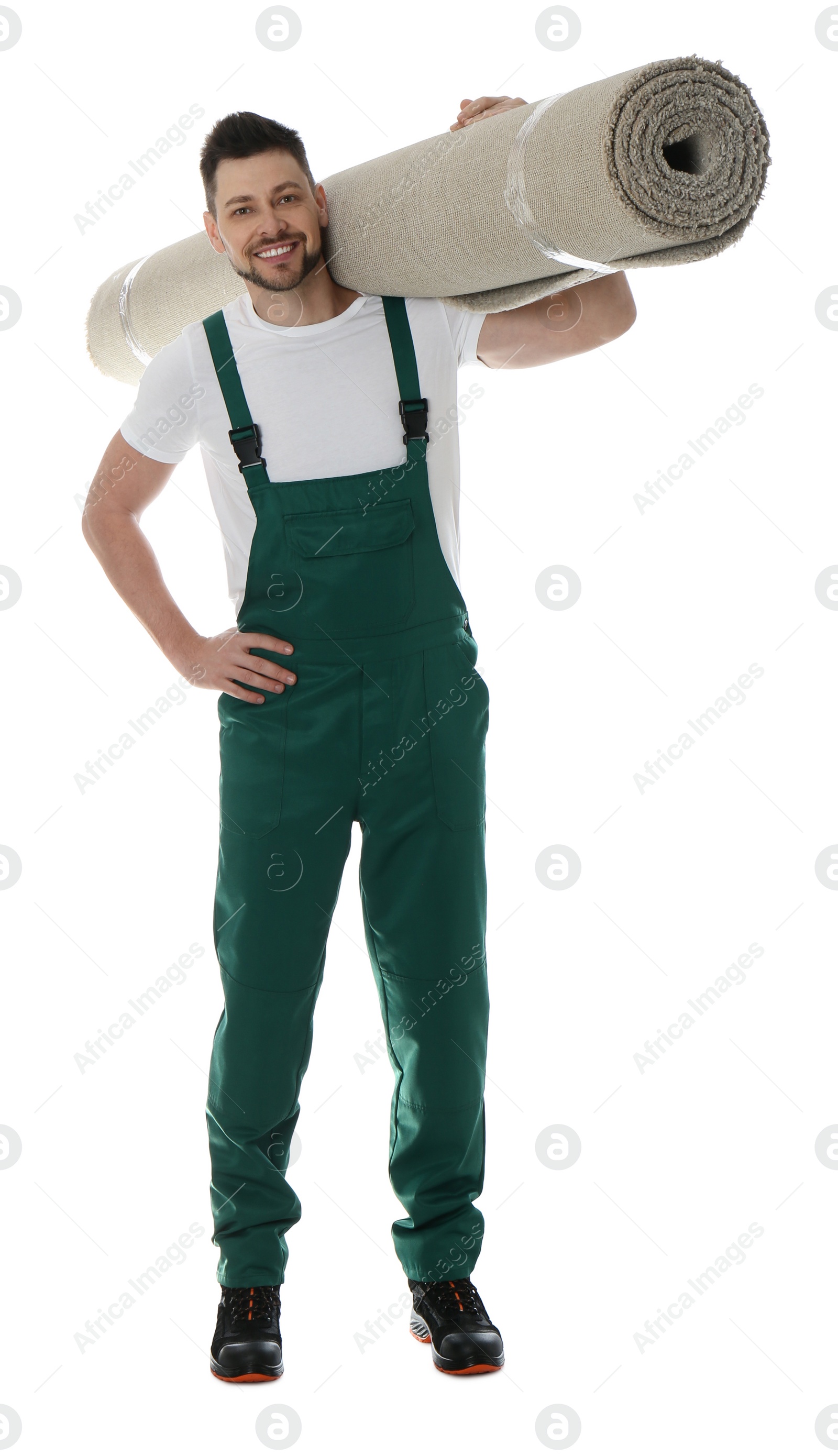 Photo of Male worker with rolled carpet on white background