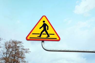 Photo of Traffic sign Pedestrian Crossing against blue sky