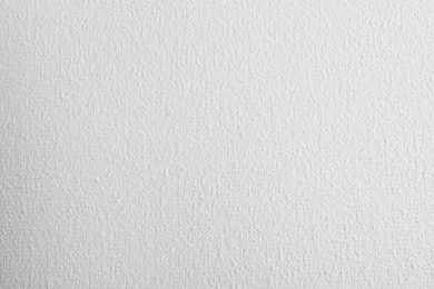 Photo of Blank white canvas as background, closeup view