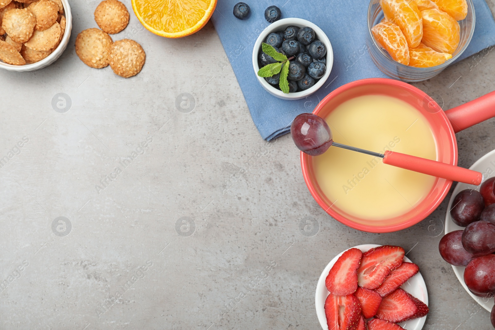 Photo of Flat lay composition with white chocolate fondue and space for text on grey stone background