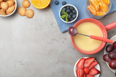 Photo of Flat lay composition with white chocolate fondue and space for text on grey stone background